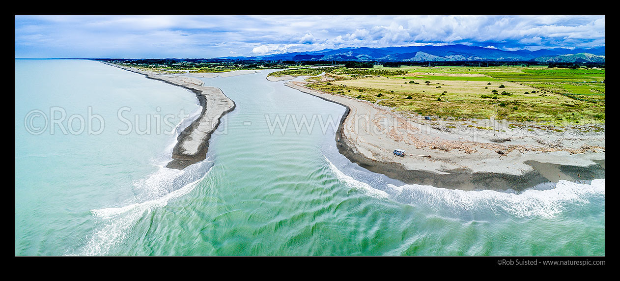 Image of Otaki River mouth and beach, with Otaki beach township beyond. Farmland stretching into the distant Tararua Forest Park ranges beyond. Aerial panorama, Otaki Beach, Kapiti Coast District, Wellington Region, New Zealand (NZ) stock photo image