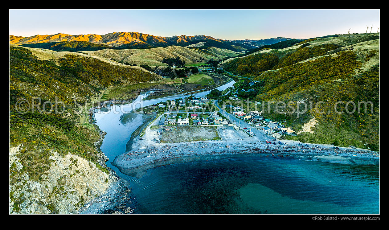 Image of Makara Beach village and Makara Stream estuary in Ohariu Bay, at twilight. Aerial panorama, Makara Beach, Wellington City District, Wellington Region, New Zealand (NZ) stock photo image