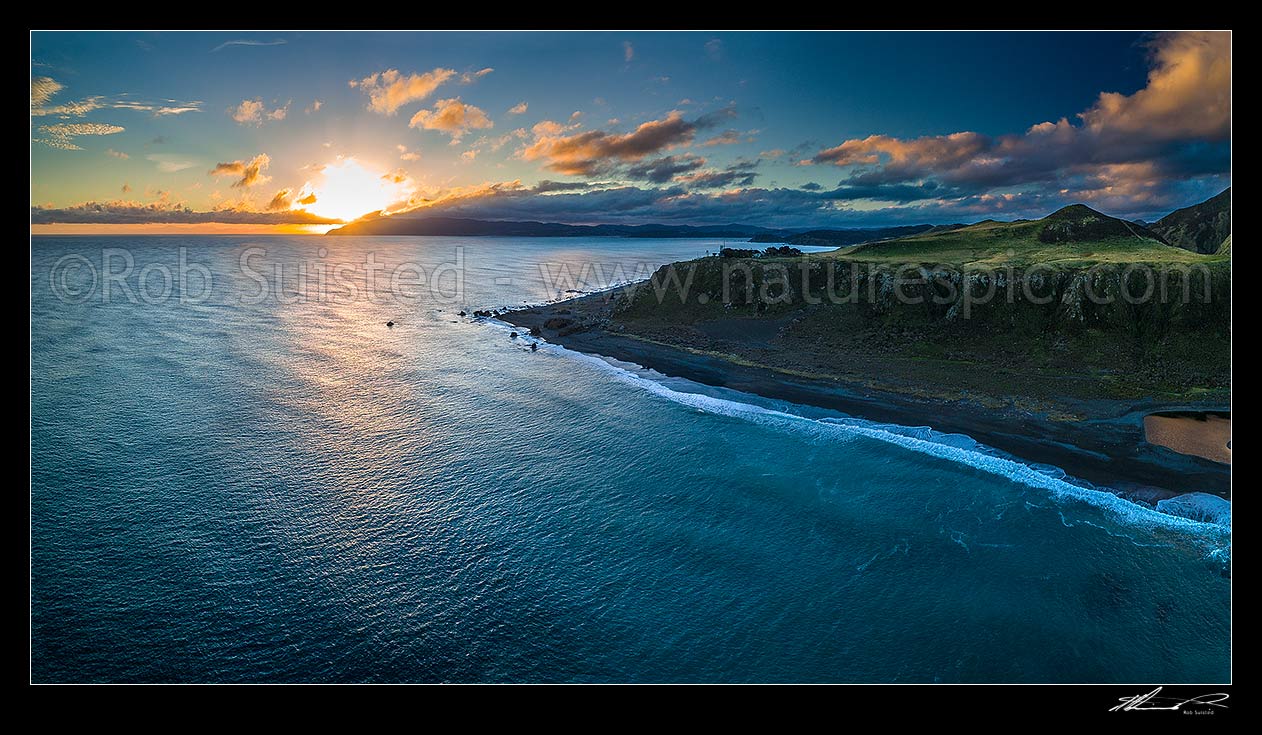 Image of Wellington Harbour entrance at sunset. Baring Head and lighthouse centre, Sinclair Head distant left. East Harbour Regional Park at right. Aerial panorama, Baring Head, Hutt City District, Wellington Region, New Zealand (NZ) stock photo image