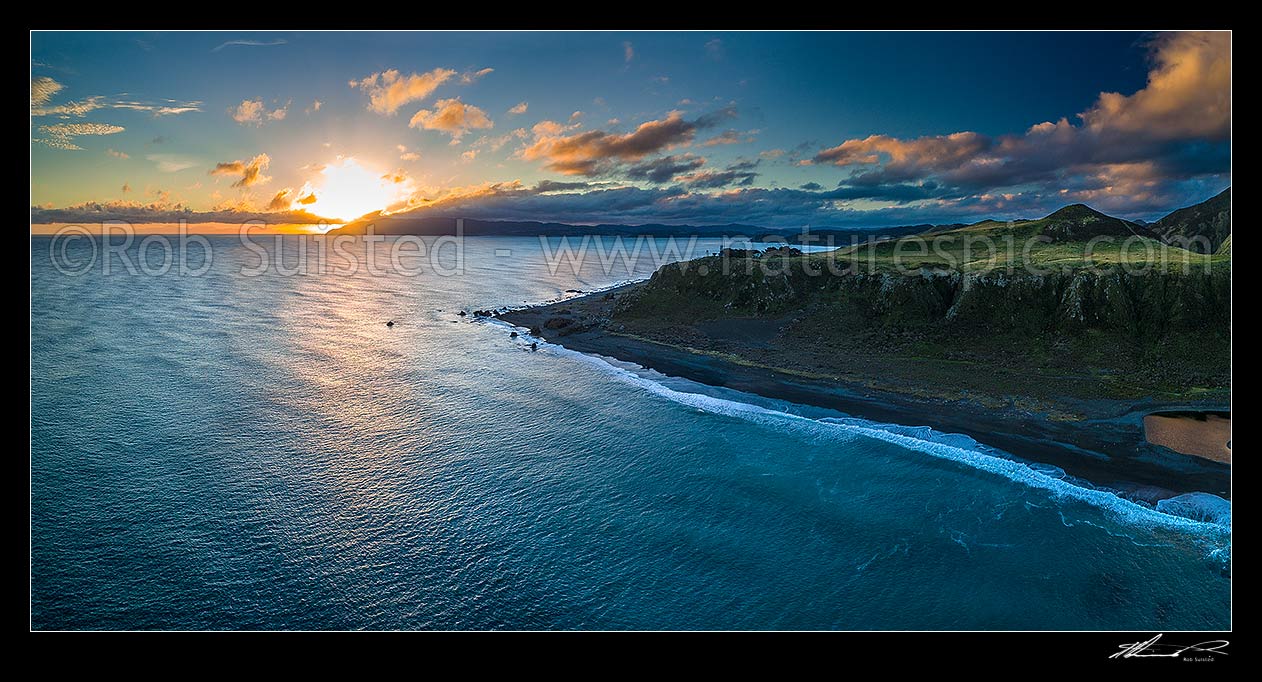 Image of Wellington Harbour entrance at sunset. Baring Head and lighthouse centre, Sinclair Head distant left. East Harbour Regional Park at right. Aerial panorama, Baring Head, Hutt City District, Wellington Region, New Zealand (NZ) stock photo image