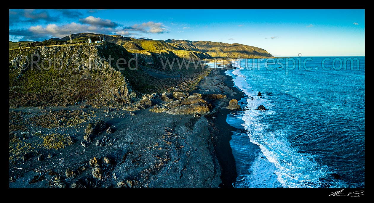 Image of Baring Head, lighthouse and rugged coastline, with Wainuiomata River mouth and Cape Turakirae Head beyond. Aerial panorama view, Baring Head, Hutt City District, Wellington Region, New Zealand (NZ) stock photo image