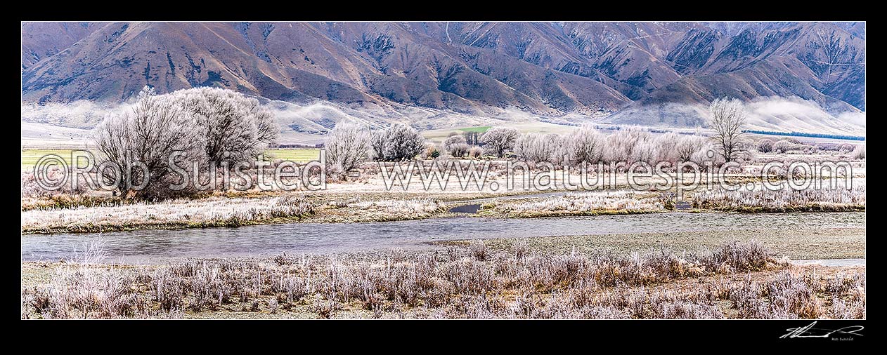 Image of Ahuriri River flats under heavy winter frosts. Benmore Range behind. Hoar frost. Panorama, Omarama, Waitaki District, Canterbury Region, New Zealand (NZ) stock photo image