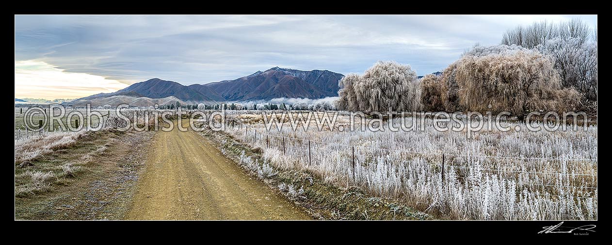 Image of Heavy frost, or hoar frost, amongst Ahuriri riverflats, trees, and farmland near Omarama. McKenzie Basin beyond at left. Panorama, Omarama, Waitaki District, Canterbury Region, New Zealand (NZ) stock photo image