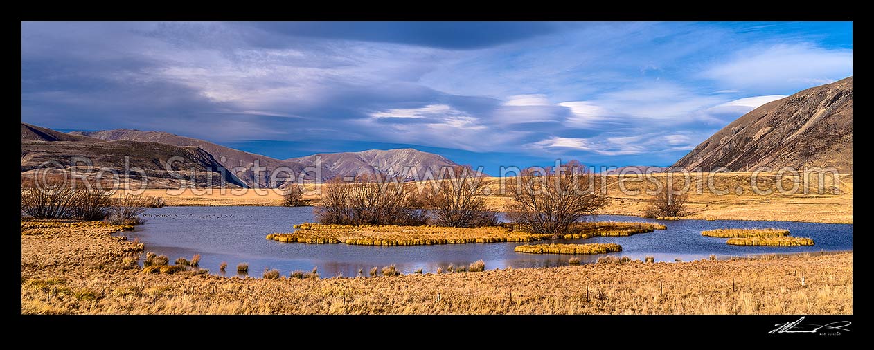 Image of Ben Avon Scenic Reserve lake and wetlands in the upper Ahuriri River Valley. Waterfowl on water. Diadem Range behind. Ben Avon Station. Panorama, Ahuriri River, Waitaki District, Canterbury Region, New Zealand (NZ) stock photo image