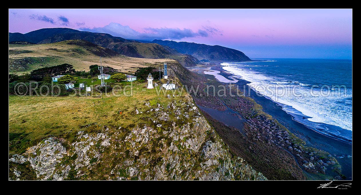 Image of Baring Head lighthouse and complex on cliffs above Baring Head. Wainuiomata River mouth and Turakirae Head beyond. Aerial panorama view at dusk, Baring Head, Hutt City District, Wellington Region, New Zealand (NZ) stock photo image