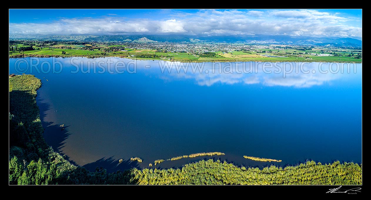 Image of Lake Horowhenua, seen from western shore. Levin and Horowhenua plains beyond, with Tararua Ranges above. Aerial panorama view, Levin, Horowhenua District, Manawatu-Wanganui Region, New Zealand (NZ) stock photo image