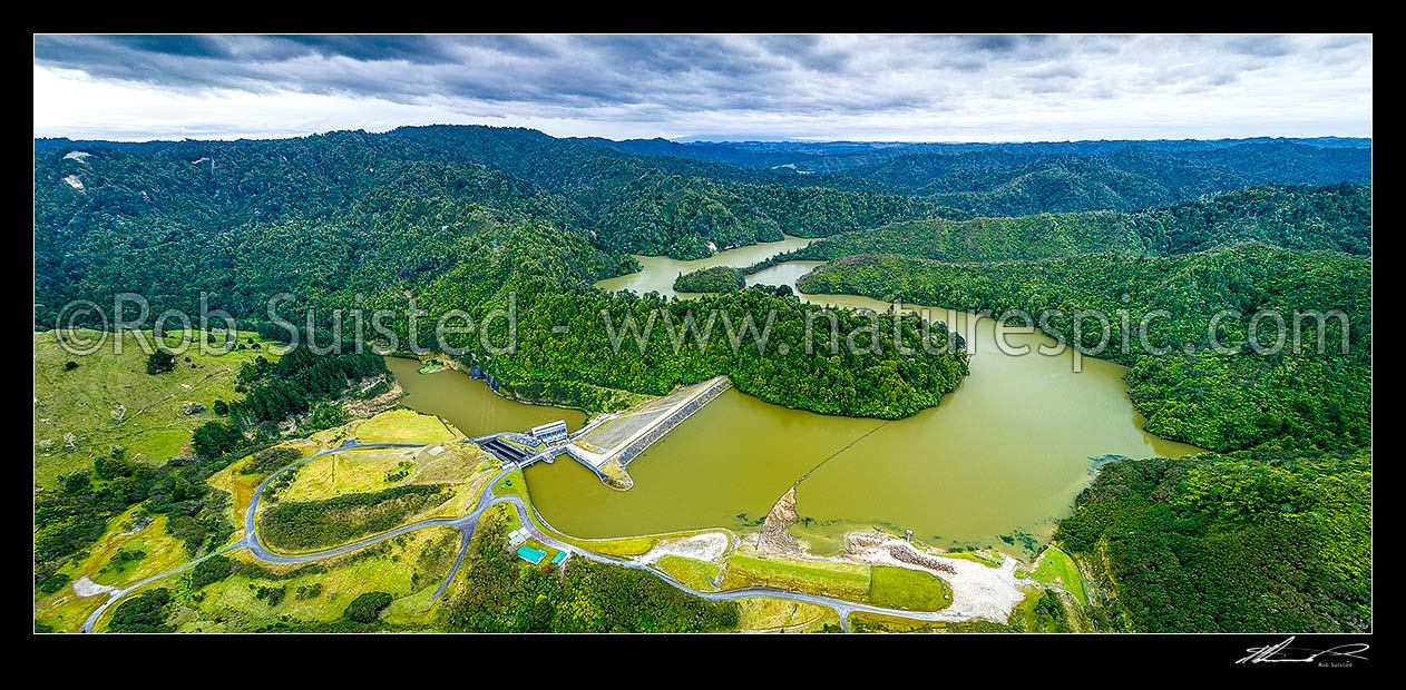 Image of Patea Dam on the Patea River, holding back Lake Rotorangi, a 46km long hydro power lake.  Patea Dam is rated at 31 MW output, 80m high, built 1984. Aerial panorama. Hurleyville, Patea, South Taranaki District, Taranaki Region, New Zealand (NZ) stock photo image