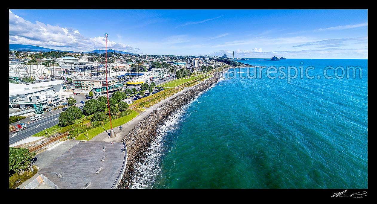 Image of Len Lye wind wand, a 48m high kinetic sculpture on New Plymouth city waterfront. New Plymouth city CBD beyond. Aerial panorama looking towards Paritutu Rock and port, New Plymouth, New Plymouth District, Taranaki Region, New Zealand (NZ) stock photo image