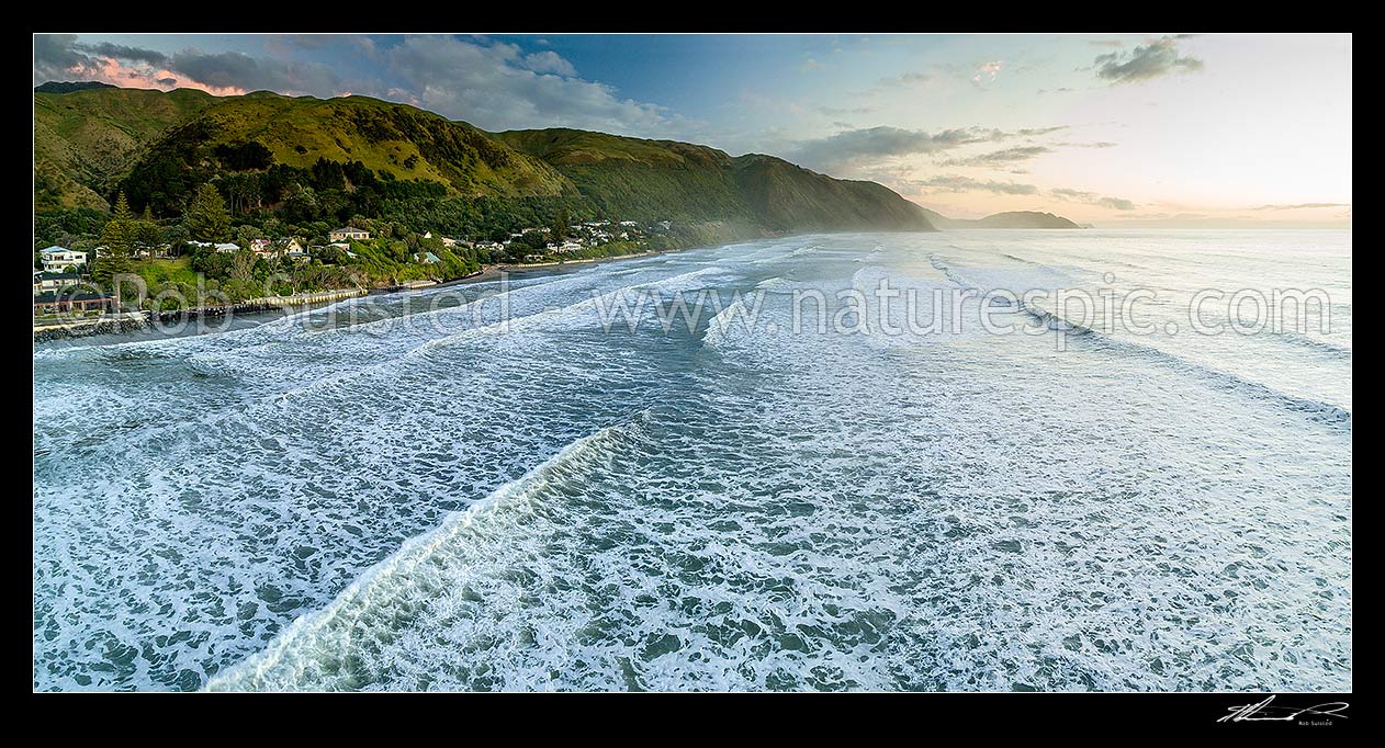 Image of Paekakariki Beach (Whareroa Beach) and houses, with a heavy swell rolling in. Waireka Point in distance. Aerial panorama, Paekakariki, Kapiti Coast District, Wellington Region, New Zealand (NZ) stock photo image