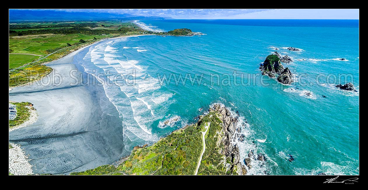 Image of Tauranga Bay Beach, with Cape Foulwind Walkway below.  Wall Island and reefs at right. Aerial panorama looking south, Cape Foulwind, Buller District, West Coast Region, New Zealand (NZ) stock photo image