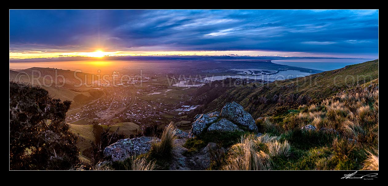 Image of Christchurch City and Canterbury Plains at sunset, from the Port Hills. Avon Heathcote Rivers estuary and Pegasus Bay right. Panorama, Port Hills, Christchurch, Christchurch City District, Canterbury Region, New Zealand (NZ) stock photo image