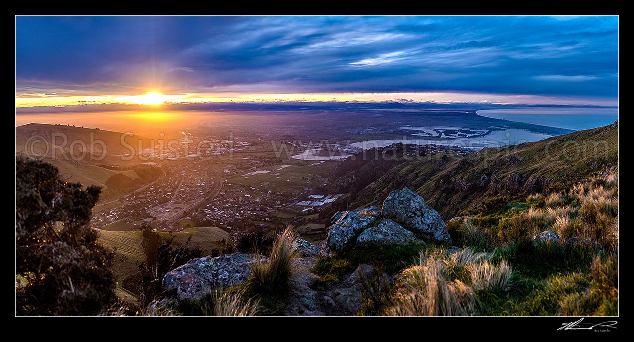 Image of Christchurch City and Canterbury Plains at sunset, from the Port Hills. Avon Heathcote Rivers estuary and Pegasus Bay right. Panorama, Port Hills, Christchurch, Christchurch City District, Canterbury Region, New Zealand (NZ) stock photo image