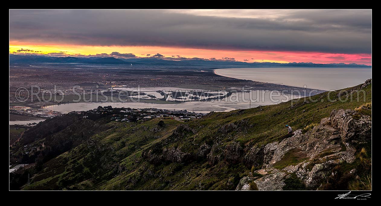 Image of Christchurch City and Canterbury plains on a calm winter evening. Heathcote and Avon Estuary, and Pegasus Bay at right. Sunset panorama, Port Hills, Christchurch, Christchurch City District, Canterbury Region, New Zealand (NZ) stock photo image