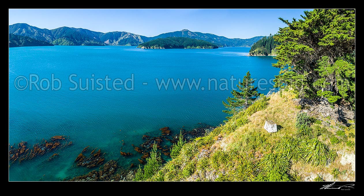 Image of Horahora Kakahu Island, where local Maori Chiefs signed the Treaty of Waitangi in 1840. Marked by cairn visible. Seperation Point beyond. Panorama, Port Underwood, Marlborough District, Marlborough Region, New Zealand (NZ) stock photo image