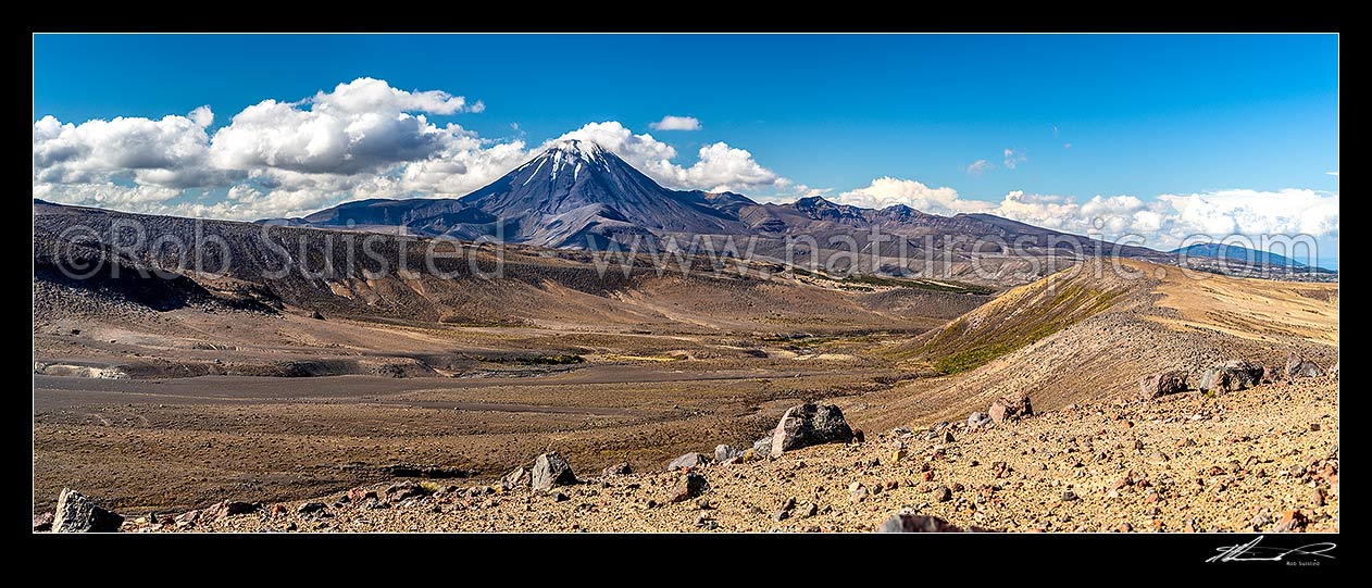 Image of Mt Ngauruhoe (2287m) standing above the dry barren volcanic landscape of the Rangipo Desert and Mangatoetoenui stream on the Round the Mountain Track. Panorama, Tongariro National Park, Taupo District, Waikato Region, New Zealand (NZ) stock photo image