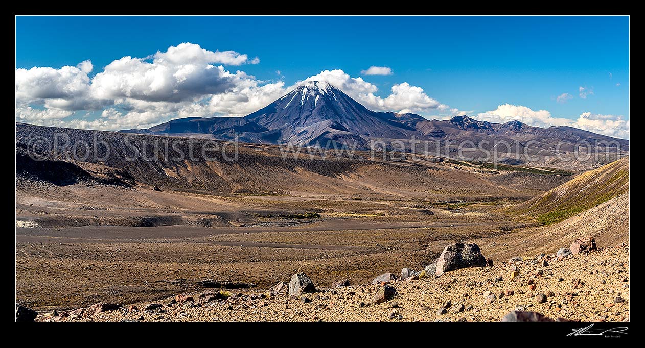 Image of Mt Ngauruhoe (2287m) standing above the dry barren volcanic landscape of the Rangipo Desert and Mangatoetoenui stream on the Round the Mountain Track. Panorama, Tongariro National Park, Taupo District, Waikato Region, New Zealand (NZ) stock photo image