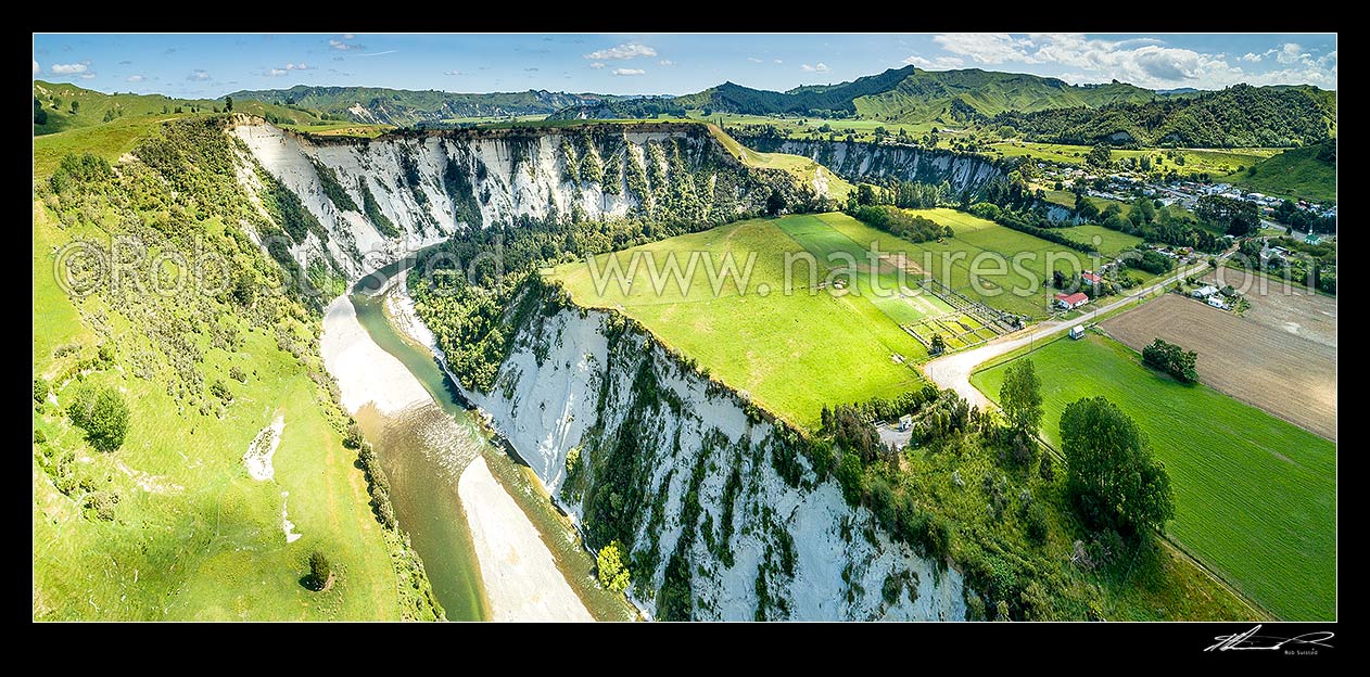 Image of Rangitikei River and white siltstone / paapa / papa cliffs distinctive of the district. Aerial panorama over river valley terraces and farmland, with Mangaweka township at right, Mangaweka, Rangitikei District, Manawatu-Wanganui Region, New Zealand (NZ) stock photo image