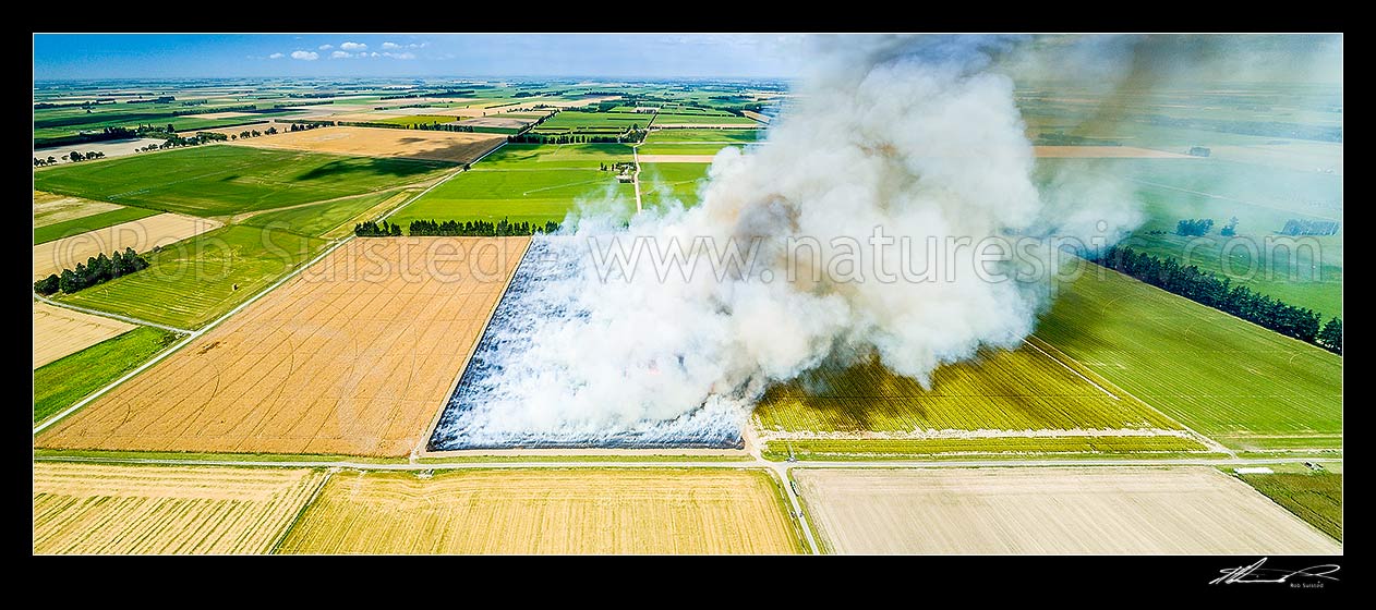 Image of Canterbury plains agricultural mosaic landscape of dairy farming and cropping. Post wheat harvest stubble burn off, a normal management tool for preparing next planting. Aerial panorama, Methven, Ashburton District, Canterbury Region, New Zealand (NZ) stock photo image