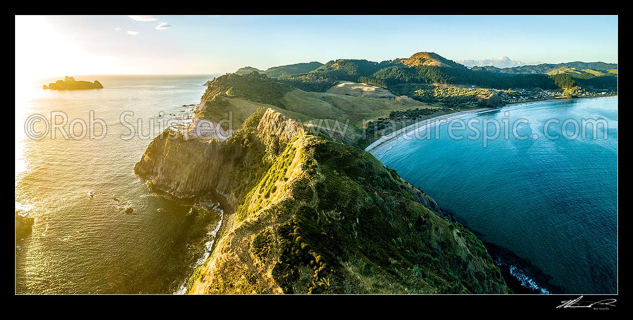 Image of Opito Point Historic Reserve at sunrise, with Motukoruenga Island far left, and Opito Bay and Opito Beach at right. Aerial panorama, Opito Bay, Coromandel Peninsula, Thames-Coromandel District, Waikato Region, New Zealand (NZ) stock photo image