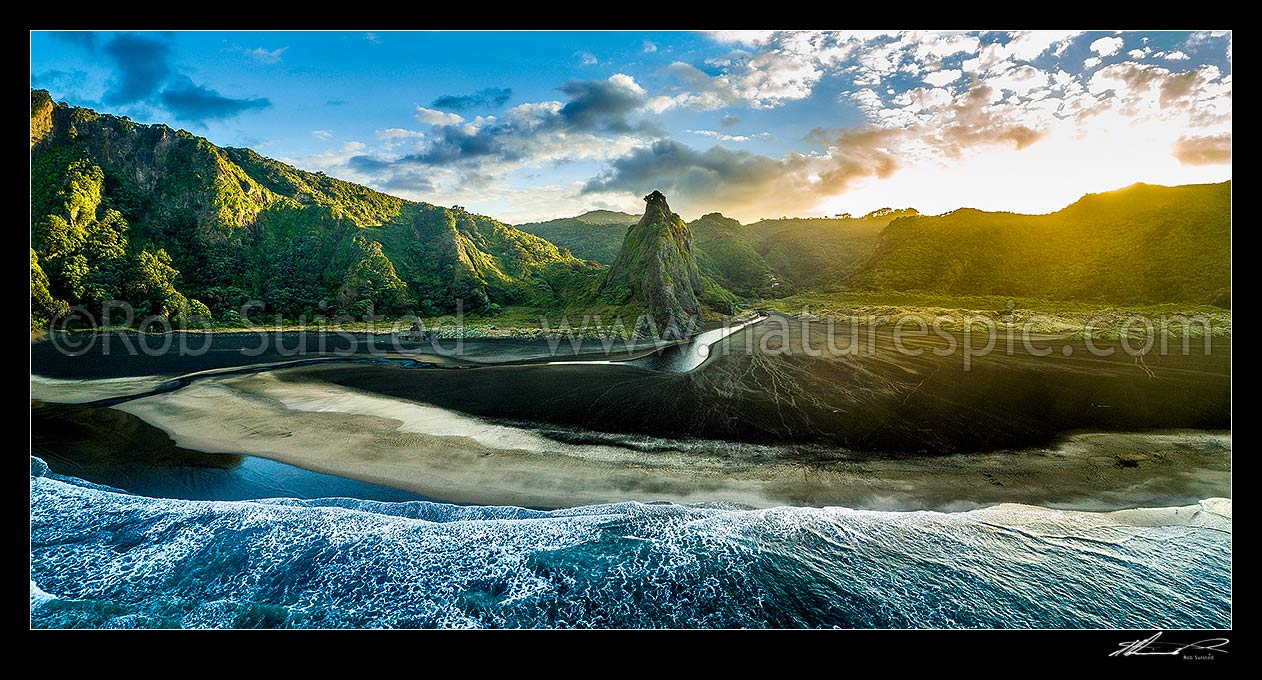 Image of Karekare Beach at dawn, with The Watchman rock and Karekare Stream centre. Waitakere Ranges behind. Moody aerial panorama, Karekare Beach, Waitakere City District, Auckland Region, New Zealand (NZ) stock photo image