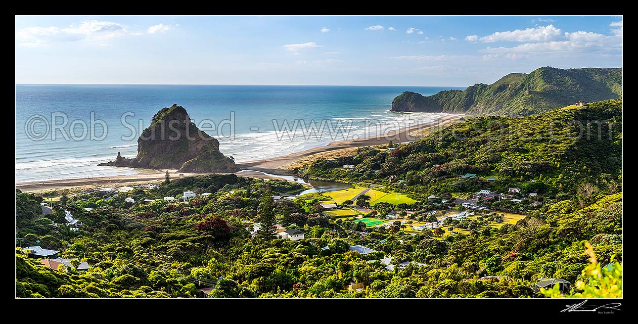 Image of Piha Beach, village and prominent Lion Rock, with North Piha Beach, Kohunui Bay, and Te Waha Point at right. Auckland West Coast. Panorama, Piha Beach, Waitakere City District, Auckland Region, New Zealand (NZ) stock photo image