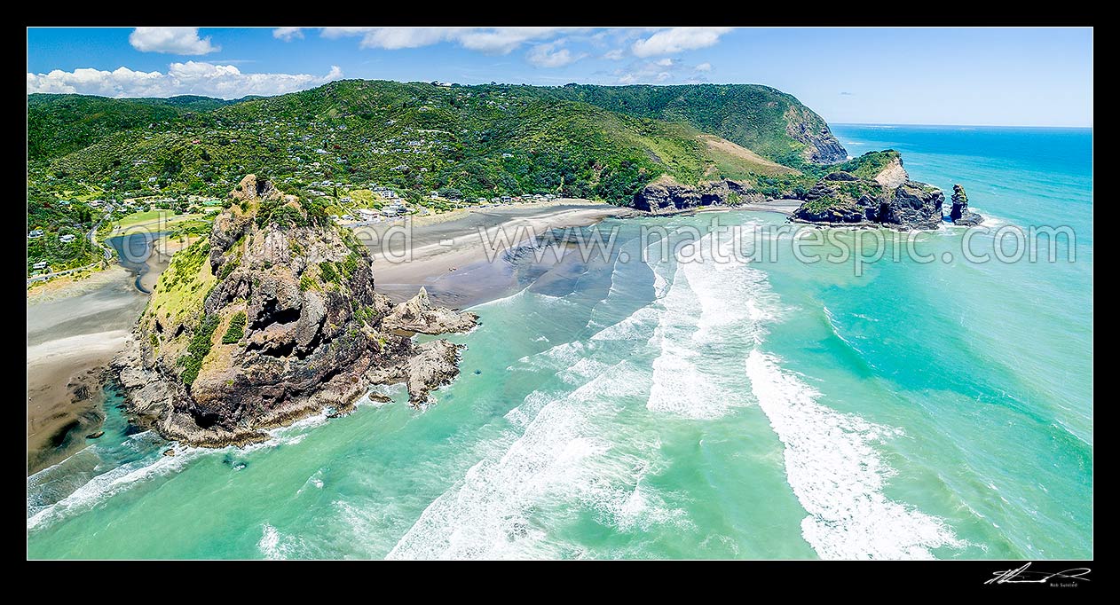 Image of Piha Beach settlement, with Lion Rock at left, looking south towards Taitomo Island, Nun Rock, Kaiwhare Point and Takatu Head. Waitakere Ranges. Aerial panorama, Piha Beach, Waitakere City District, Auckland Region, New Zealand (NZ) stock photo image