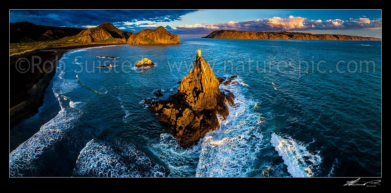 Image of Whatipu Beach and Manukau Harbour entrance made safe by the Ninepin Rock lighthouse beacon. South Head at right. Moody evening aerial panorama, Whatipu Beach, Waitakere City District, Auckland Region, New Zealand (NZ) stock photo image