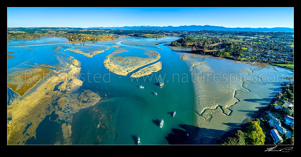 Image of Waimea Inlet estuary looking NW from Mapua towards Kahurangi National Park. Aerial panorama over sand and mudflats at low tide with boats moored off Grossi Point, Mapua, Tasman District, Tasman Region, New Zealand (NZ) stock photo image