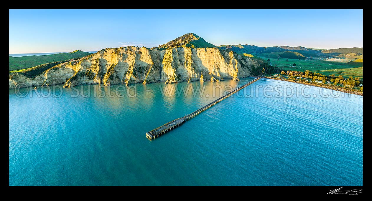 Image of Tolaga Bay wharf at dawn.  NZ's longest wharf at 660 metres. Aerial panorama, Tolaga Bay, Gisborne District, Gisborne Region, New Zealand (NZ) stock photo image