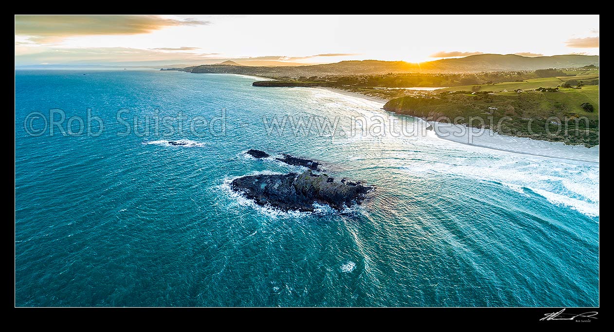 Image of Dunedin South Coast, looking past Bird Island towards St Kilda Beach (left), Lawyers Head, Tomahawk Beach and Smaills Beach (right). Aerial panorama at sunset, Otago Peninsula, Dunedin City District, Otago Region, New Zealand (NZ) stock photo image