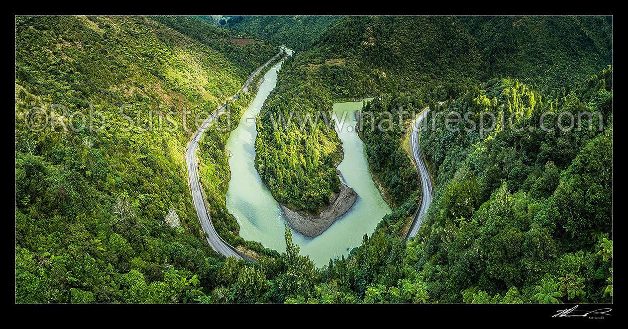 Image of Waioeka River and gorge, with State Highway 2 winding through. Waioeka Gorge Scenic Reserve. Aerial panorama looking upstream over major bend, Waioeka Gorge, Opotiki District, Bay of Plenty Region, New Zealand (NZ) stock photo image