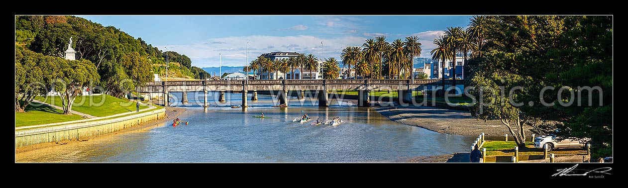 Image of Gisborne City and Turanganui River, with young people practicing Waka Ama outrigger canoe racing near the Gladstone Road Bridge. Panorama, Gisborne City, Gisborne District, Gisborne Region, New Zealand (NZ) stock photo image