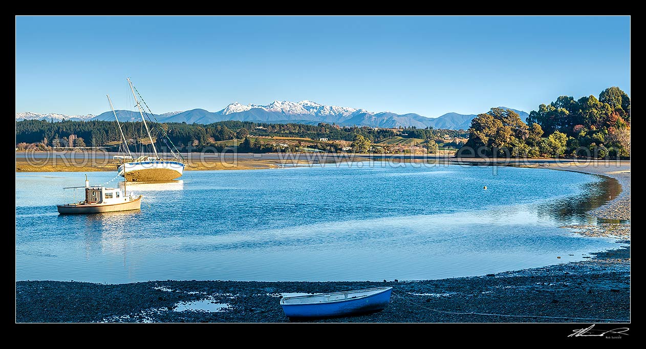 Image of Waimea Inlet at low tide with boats on moorings at Mapua. Kahurangi National Park and Arthur Range beyond. Panorama, Mapua, Tasman District, Tasman Region, New Zealand (NZ) stock photo image