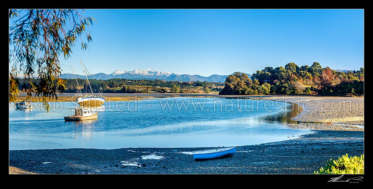 Image of Waimea Inlet at low tide with boats on moorings at Mapua. Kahurangi National Park and Arthur Range beyond. Panorama, Mapua, Tasman District, Tasman Region, New Zealand (NZ) stock photo image