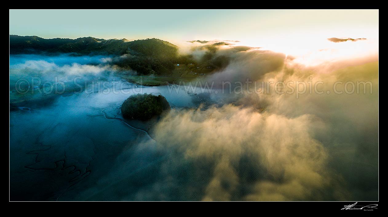 Image of Mokau River estuary at low tide, in morning mist as cold air travels towards the coast. Moody misty sunrise, Te Mahoe Road. Aerial panorama. North Taranaki, Mokau, Waitomo District, Waikato Region, New Zealand (NZ) stock photo image