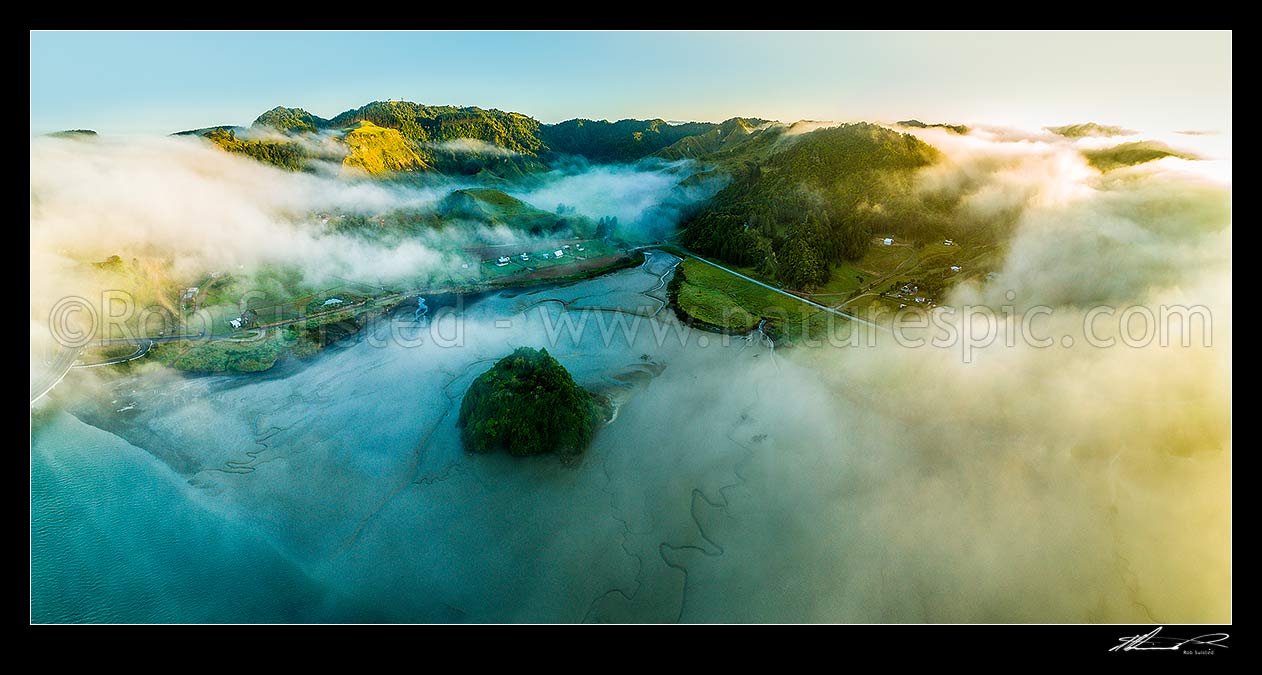 Image of Mokau River estuary at low tide, in morning mist as cold air travels towards the coast. Moody misty sunrise, Te Mahoe Road, Mt Pahaoa above. Aerial panorama. North Taranaki, Mokau, Waitomo District, Waikato Region, New Zealand (NZ) stock photo image