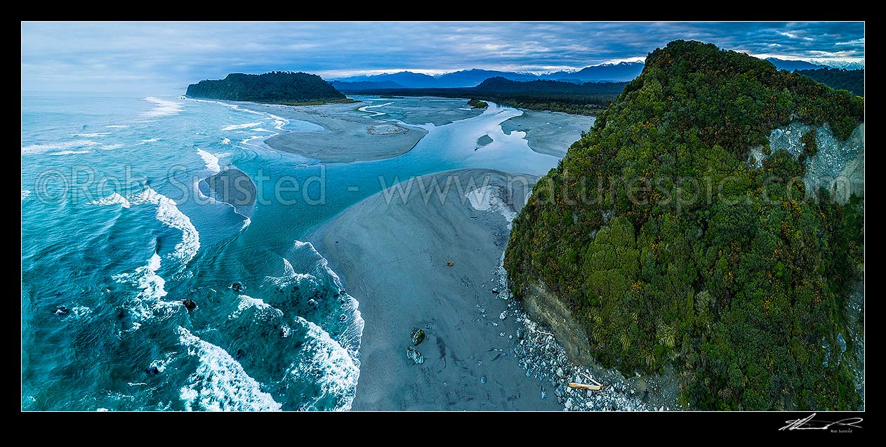 Image of Wanganui River mouth and Wanganui Heads at dawn. Wanganui Bluff left, Mt Oneone (56m) right. Aerial view with Southern Alps in distance, Harihari, Westland District, West Coast Region, New Zealand (NZ) stock photo image