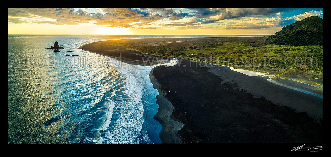 Image of Whatipu Beach sunset over black ironsands.  Ninepin Rock at left, Amphlett Stream centre, and Sargent Point far right. Aerial panorama, Whatipu Beach, Waitakere City District, Auckland Region, New Zealand (NZ) stock photo image