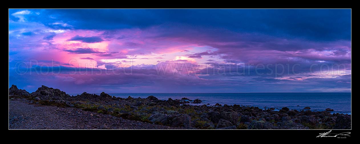 Image of Turakirae Head Scientific Reserve with twilight coloured sky above at sunset. Cook Strait beyond. Panorama, Turakirae Head, Hutt City District, Wellington Region, New Zealand (NZ) stock photo image