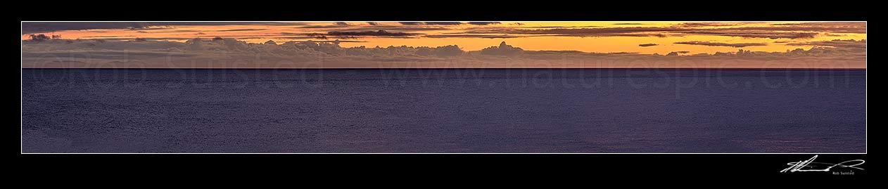 Image of Cook Strait sunset and twilight over an unusually benign sea, with could formations over the South Island Coast. Very wide panorama, Turakirae Head, Hutt City District, Wellington Region, New Zealand (NZ) stock photo image