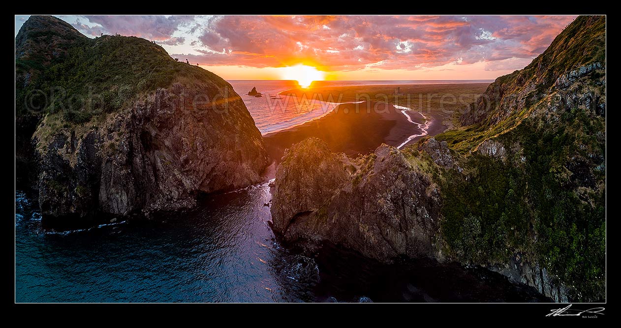 Image of Whatipu Beach sunset beyond Paratutae Island (left) and Ninepin Rock. Burnett Head centre. Aerial panorama, Whatipu Beach, Waitakere City District, Auckland Region, New Zealand (NZ) stock photo image