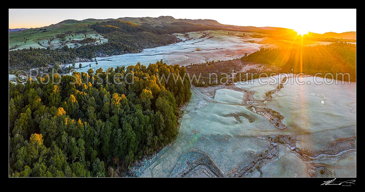 Image of Balls Clearing Scenic Reserve and Clifton Conservation Area at dawn with heavy frost, as sun rises. Mt Hukanui (988m) above. Headwaters of Mangatutu Stream. Aerial panorama, Puketitiri, Hastings District, Hawke's Bay Region, New Zealand (NZ) stock photo image