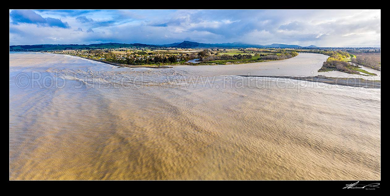 Image of Tukituki River mouth and estuary, in flood after heavy rain. Town of Haumoana at left, with Te Mata Peak beyond. Aerial panorama, Clive, Hastings District, Hawke's Bay Region, New Zealand (NZ) stock photo image