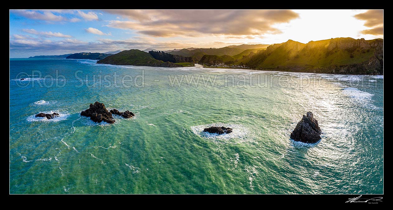 Image of Kairakau Beach village on the Mangakuri River mouth at sunset with Hinemahanga Rocks in foreground. Aerial panorama, Kairakau Beach, Hawke's Bay Region, New Zealand (NZ) stock photo image