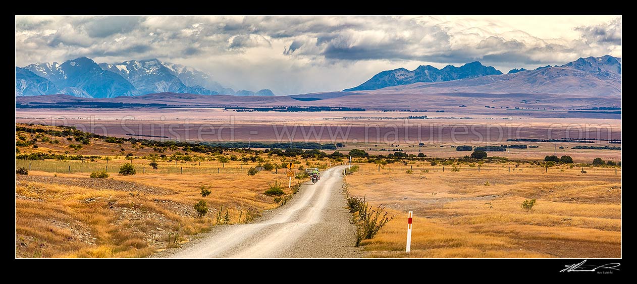 Image of MacKenzie Basin high country, looking from near Hakataramea Pass to Souithern Alps. Adventure touring motorcycle travelling back road. Panorama, Hakataramea, MacKenzie District, Canterbury Region, New Zealand (NZ) stock photo image