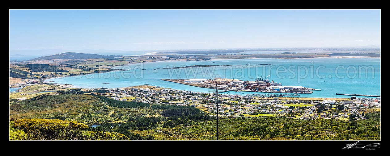 Image of Bluff Harbour with Bluff Port and township centre. View from Bluff Hill. Oreti Beach and New River Estuary distant left. Panorama, Bluff, Invercargill District, Southland Region, New Zealand (NZ) stock photo image