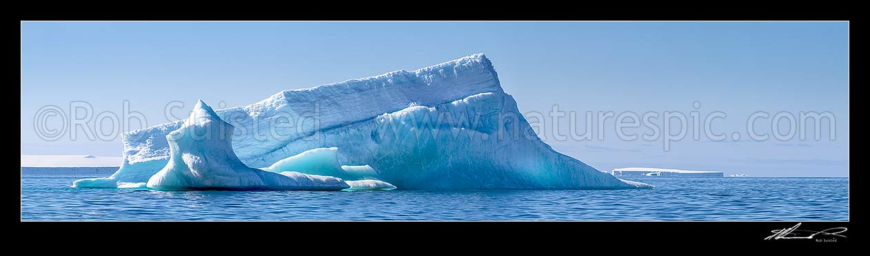 Image of Blue iceberg with translucent side floating in Terra Nova Bay. Panorama. Wider version of 56166UI00, Ross Sea, Antarctica Region, New Zealand (NZ) stock photo image