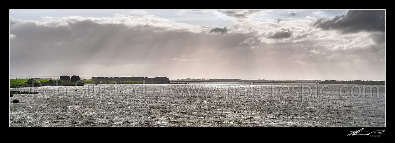 Image of Lake Waikare, on a moody spring day. Duck hunting maimais dotting the lake.  Panorama, Te Kauwhata, Waikato District, Waikato Region, New Zealand (NZ) stock photo image