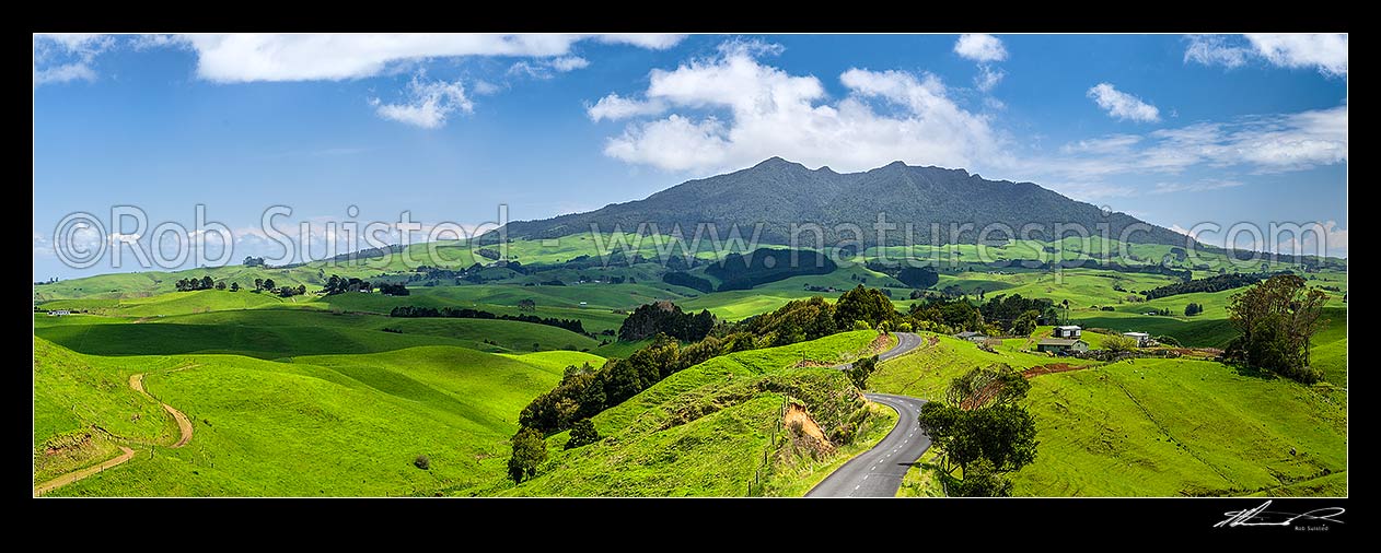 Image of Mount Karioi (756m) high above coastal Waikato farmland. Panorama over lush rural land, Raglan, Waikato District, Waikato Region, New Zealand (NZ) stock photo image