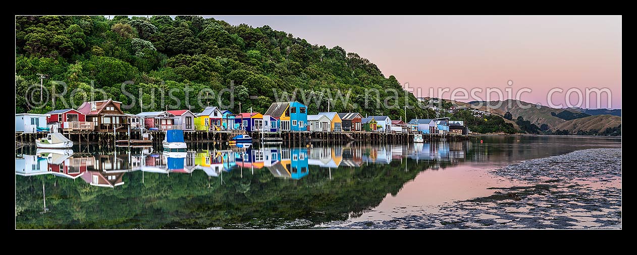 Image of Boatsheds at Mana on the Pauatahanui Arm Inlet of the Porirua Harbour, with boats on moorings. Evening twilight. Panorama, Paremata, Porirua City District, Wellington Region, New Zealand (NZ) stock photo image